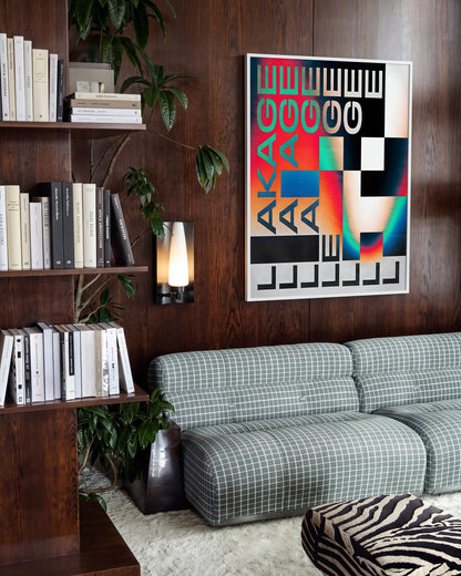 Leakage retro typography print in a white frame on a room wall