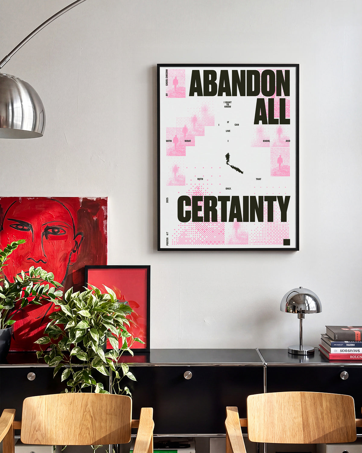 Abandon all certainty minimalist quote print in a black frame on a wall