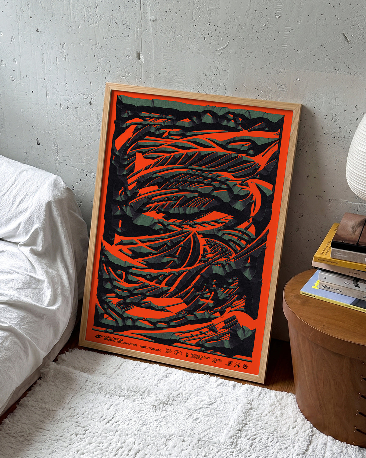 Black stone abstract art print in an oak frame on a wall