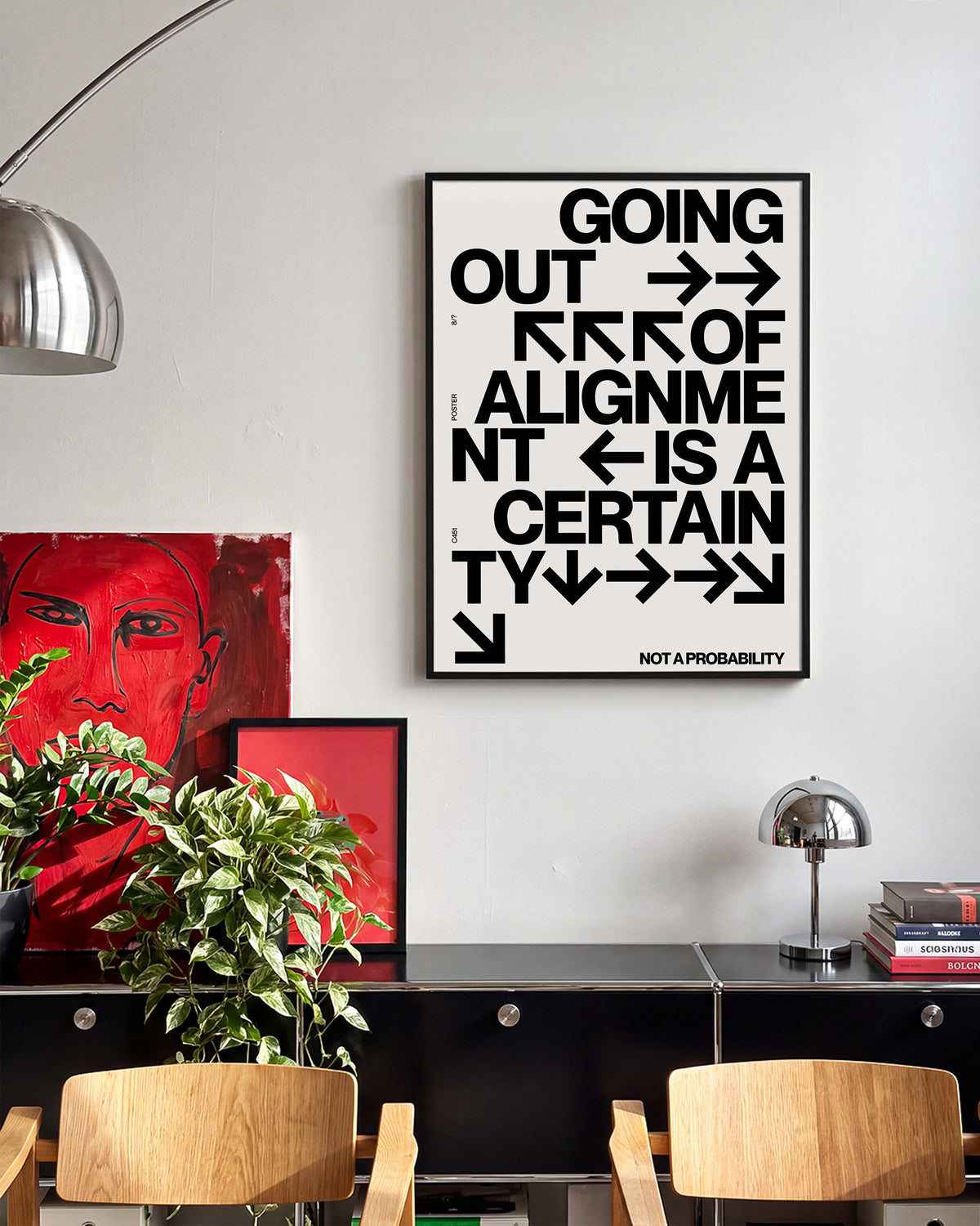 Out of Alignment typography quote print in a black frame on a wall