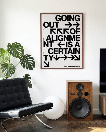 Out of Alignment typography quote print in a walnut frame on a wall