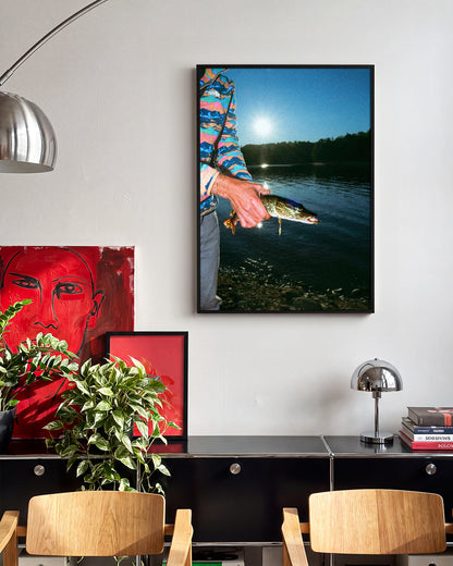 First Catch fishing photography print in a black frame on a wall
