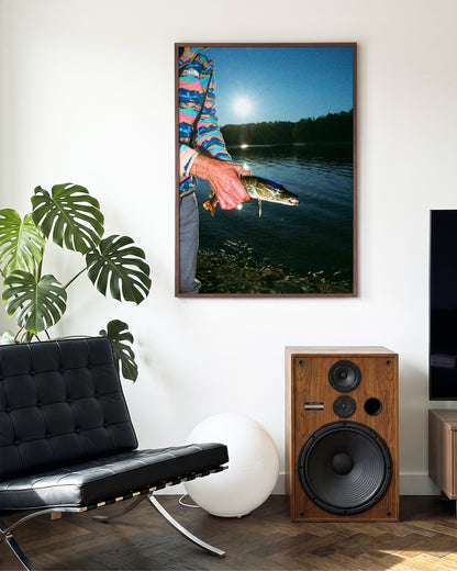 First Catch fishing photography print in a walnut frame on a wall