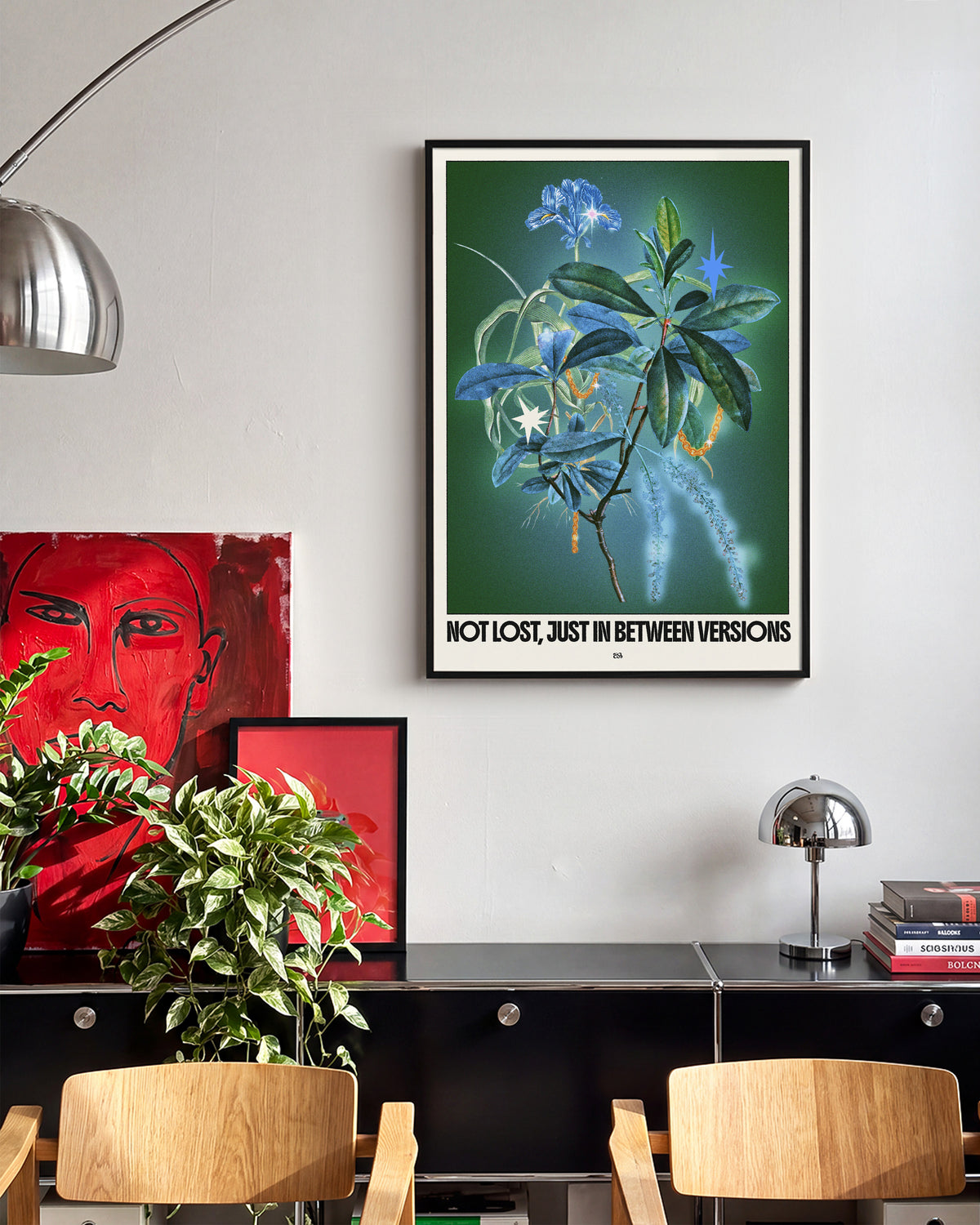 Between versions retro quote collage print in a black frame on a wall