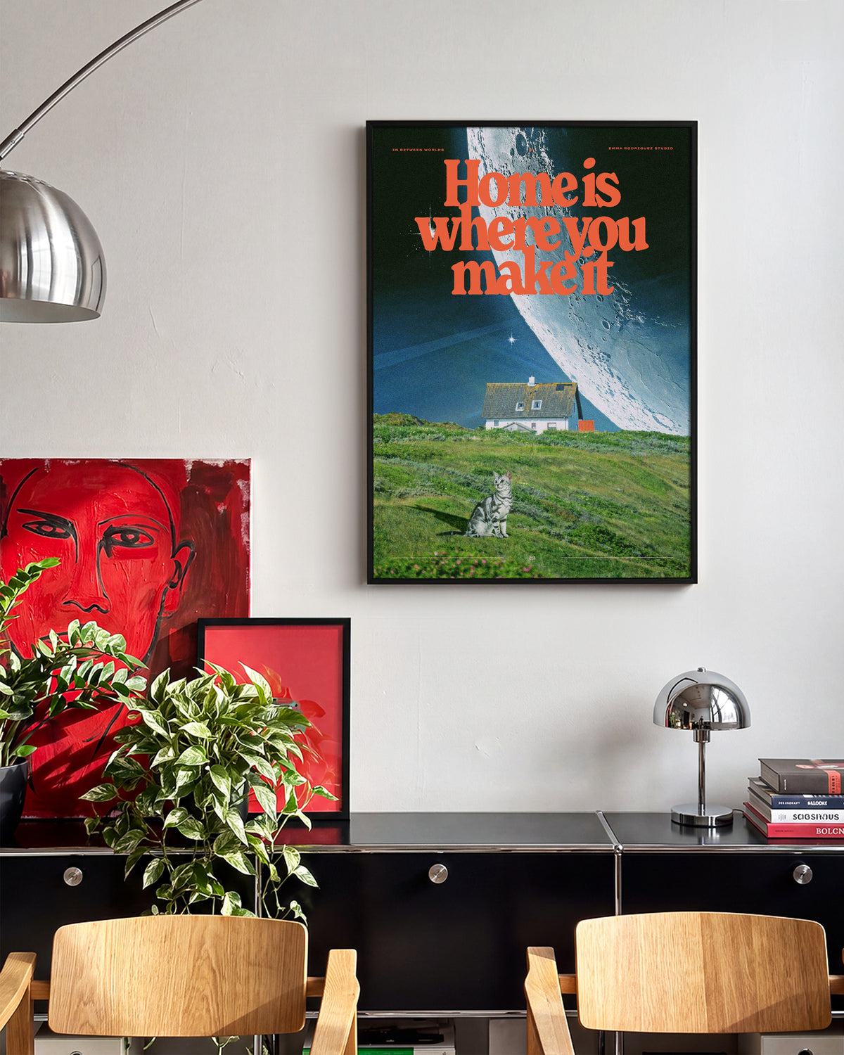 Between worlds retro space collage print in a black frame on a wall