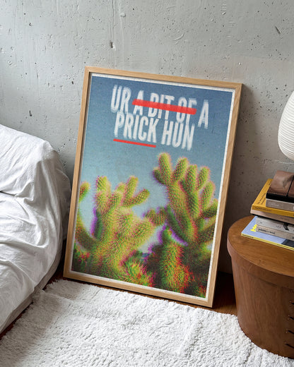 Bit of a Prick funny cactus quote poster in an oak frame on a wall