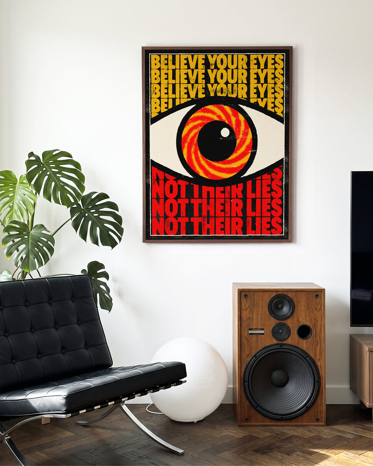 Believe Your Eyes psychedelic quote poster in a walnut frame on a wall