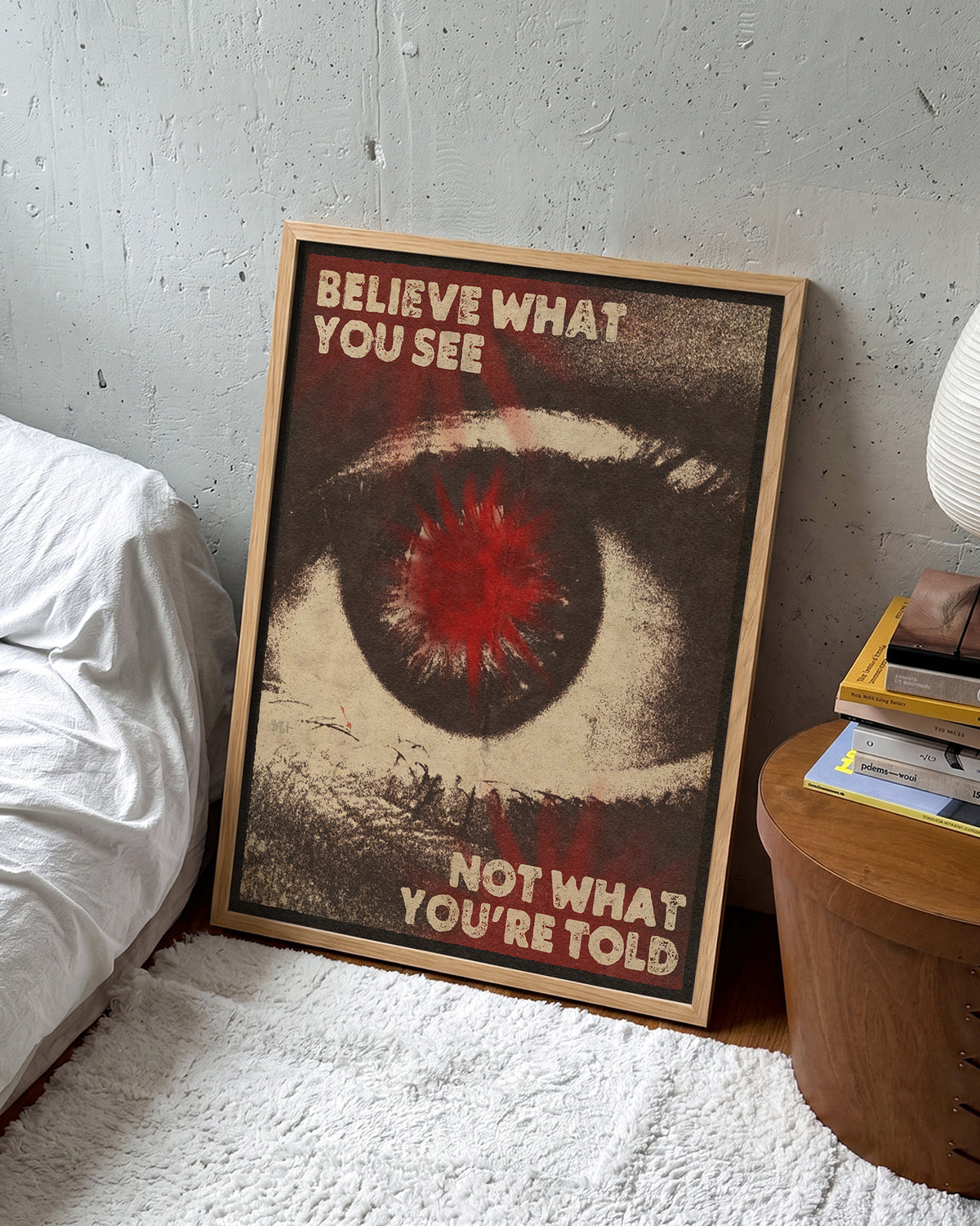 Believe What You See retro quote poster in an oak frame on a wall