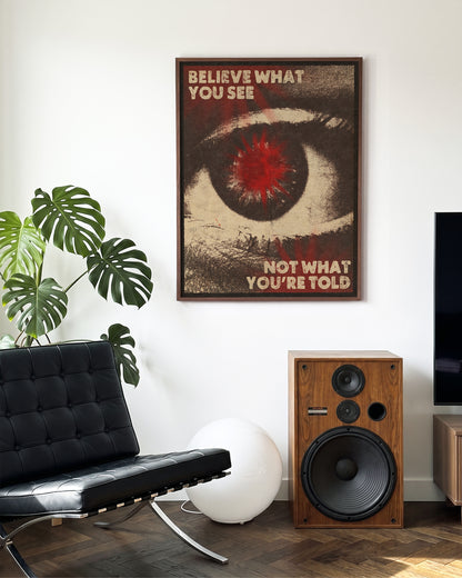 Believe What You See retro quote poster in a walnut frame on a wall