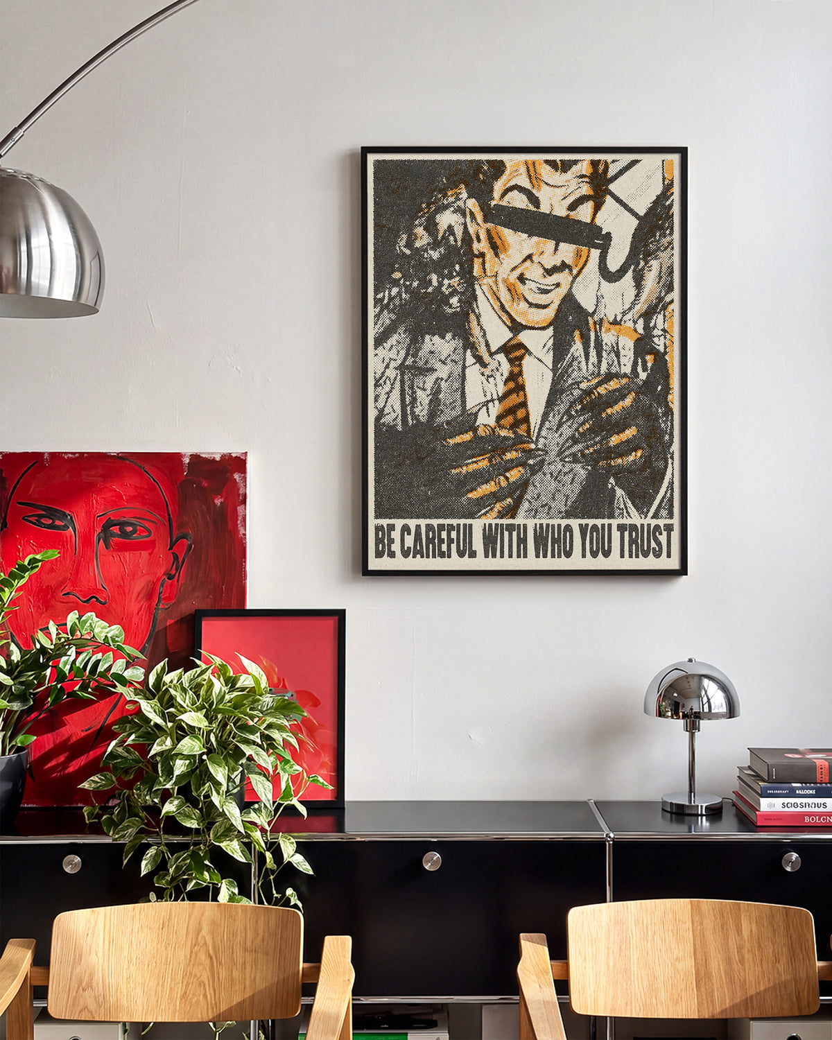 Be Careful Who You Trust retro quote poster in a black frame on a wall