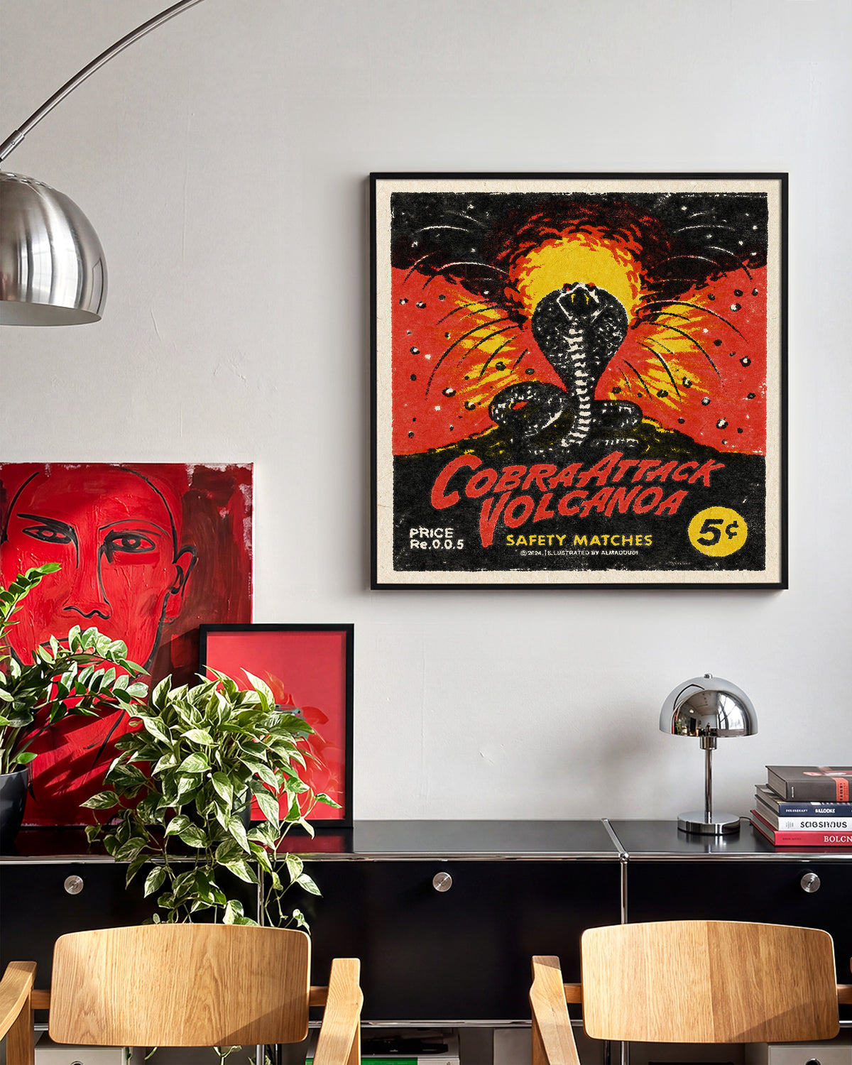 Cobra Attack Volcanoa vintage cobra tattoo print in a black frame on a wall