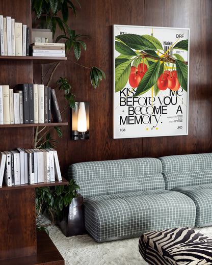 Kiss Me romantic quote poster in a white frame on a room wall